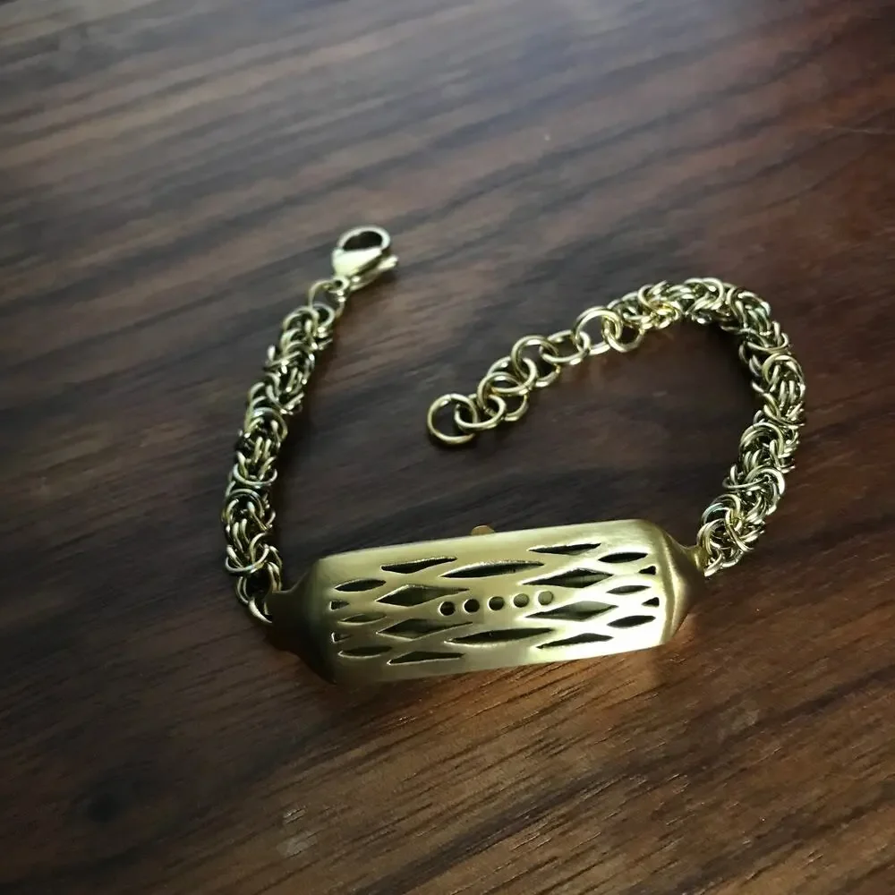 Brushed gold tone bracelet w/ a compartment for a fitbit device